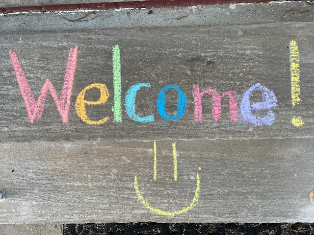 Colorful chalk welcome sign with smiley face representing acceptance therapy approach to anxiety