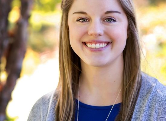 Professional portrait of Rebecca Dorich, therapist, smiling outdoors