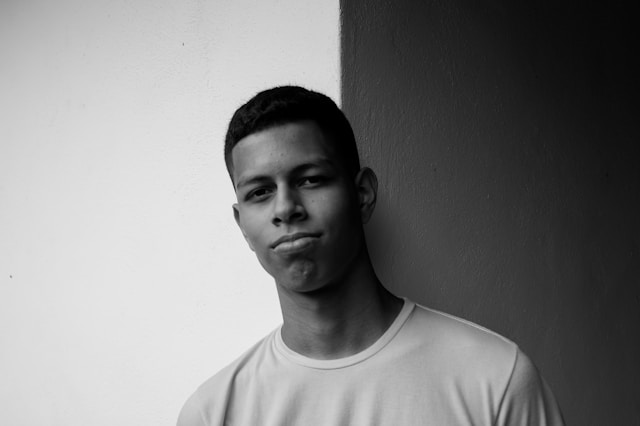 Young man with contemplative expression showing signs of control anxiety and uncertainty