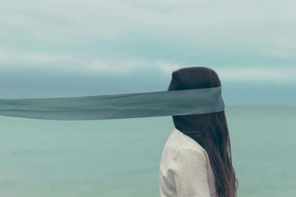 Person with fabric covering eyes symbolizing loss of control and uncertainty in anxiety