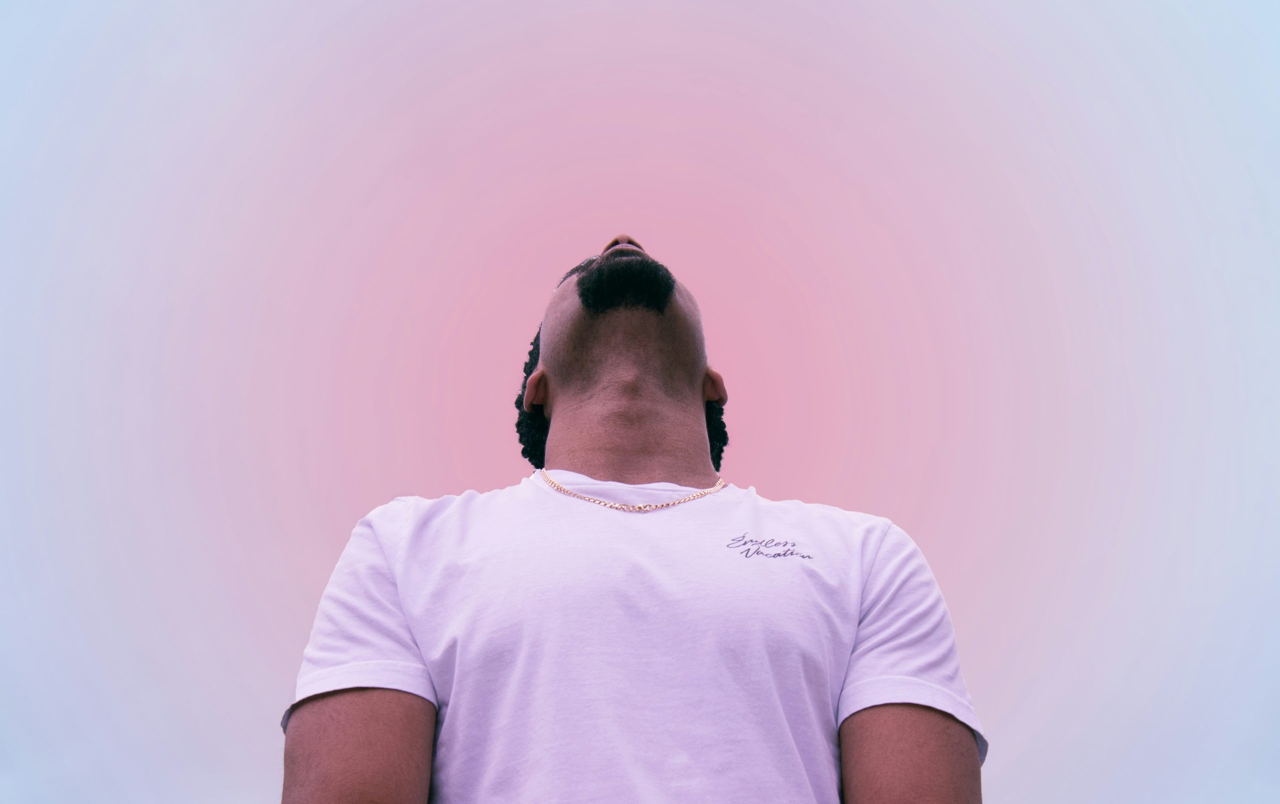 Person looking up at peaceful sky representing openness and acceptance in anxiety treatment
